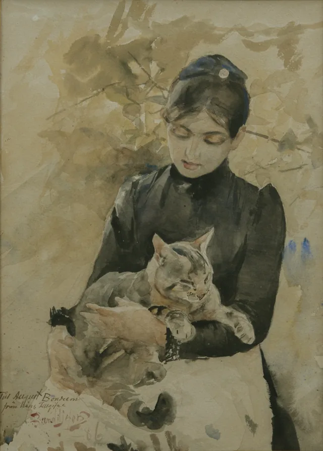 猫を抱いて座る女