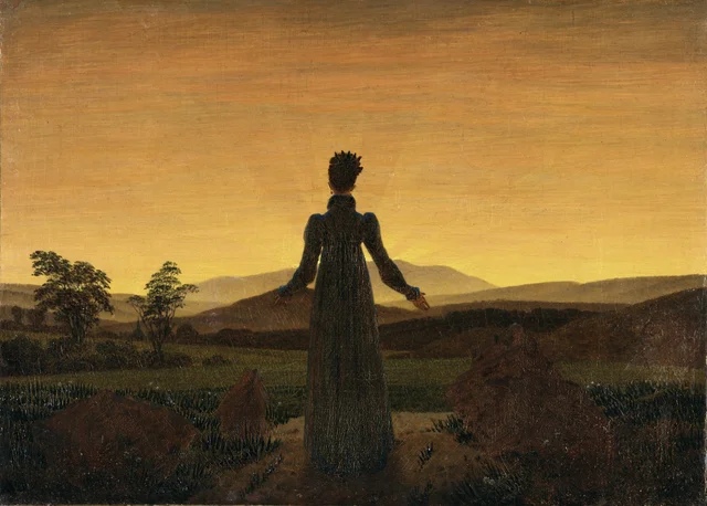 Mujer ante la puesta de sol