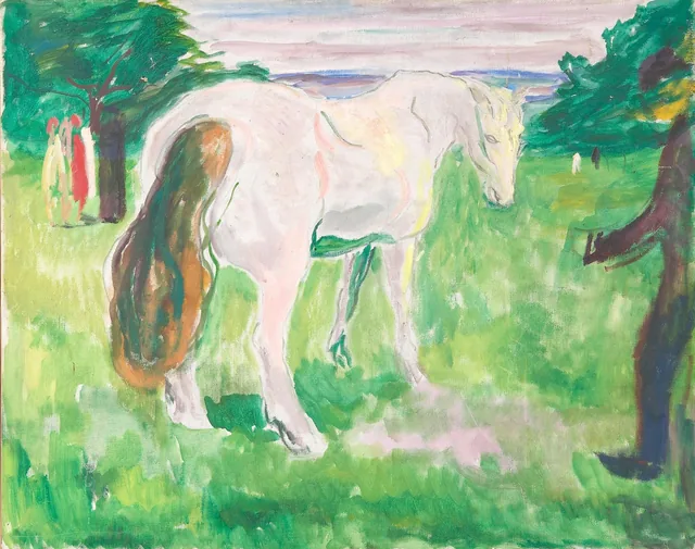 緑の草原の白い馬