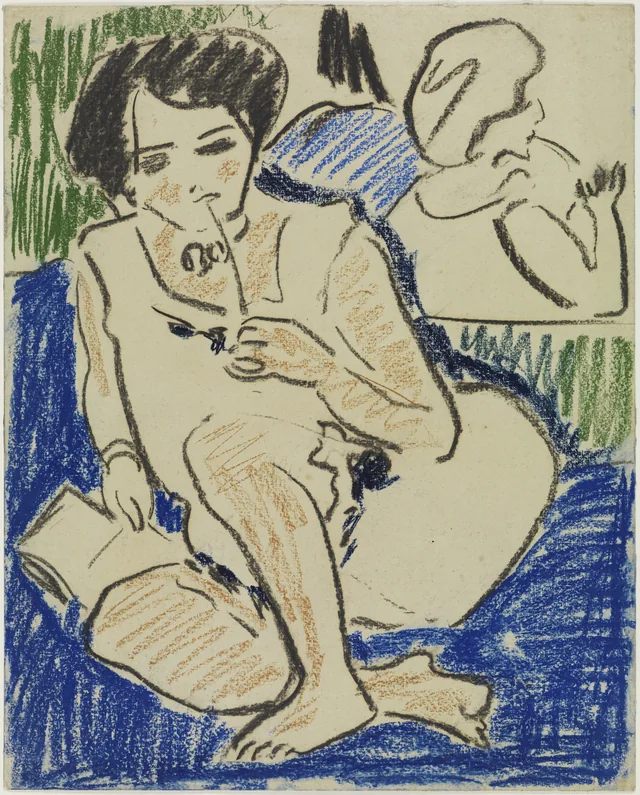 本を持ってしゃがむ女