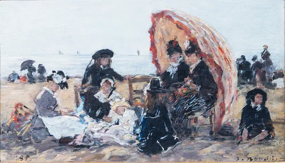 Sur la plage de Trouville, à l’abri du parasol rouge