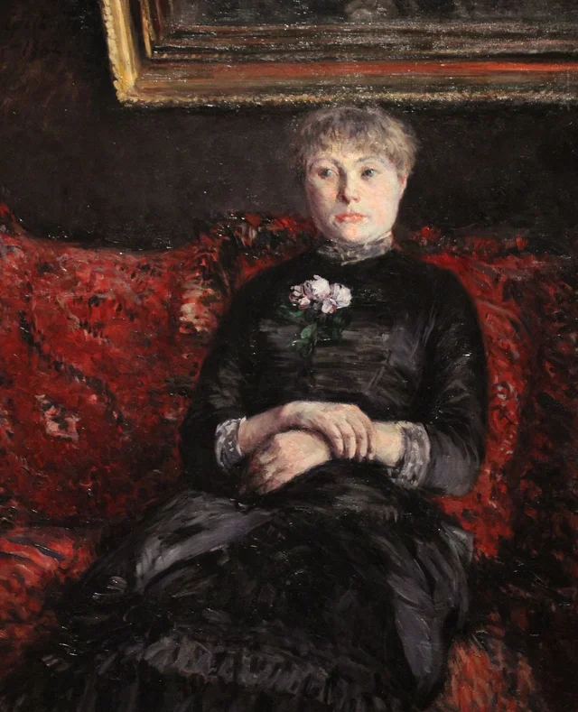 Mulher sentada num canapé de flores vermelhas, Gustave Caillebotte