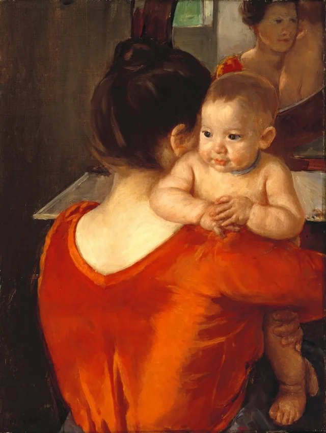 Mujer con corpiño rojo y su hijo