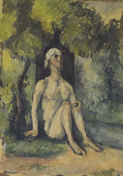 Baigneur assis au bord de l'eau