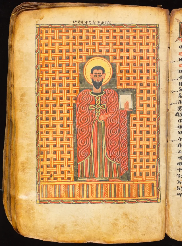 Book of the Gospels: standing evangelist holding a book against a woven background