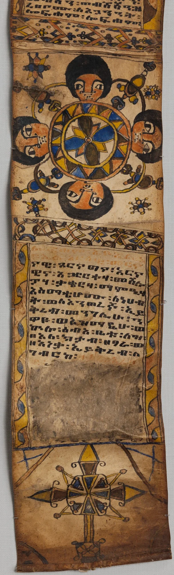Healing scroll (tälsäm): four faces around a rosette