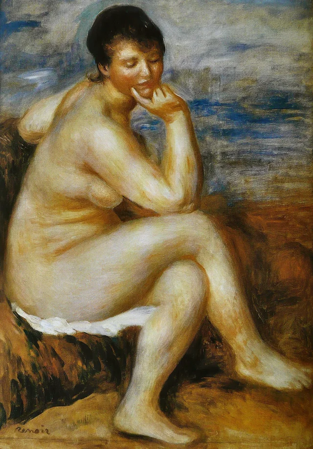 Bañista sentada sobre una roca