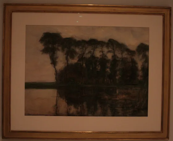Farmstead along the water screened by nine tall trees