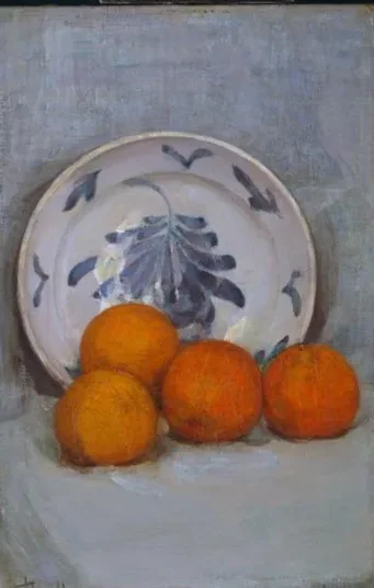 Oranges and decorated plate